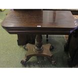 19th century mahogany D-end card table raised on a turned column and quatre base with paw feet,