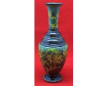 Small Royal Doulton faience baluster vase decorated with sprays of flowers, 9