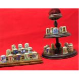 A collection of fifteen modern Royal Crown Derby Thimbles, together with matching stand and pin-