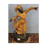 Far Eastern carved hardwood and gilt highlighted model of a dancing figure, 21" high