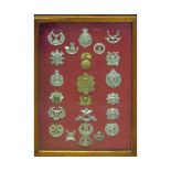 Framed collection of 23 British military cap badges, predominantly Scottish Regiments and mounted on