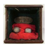 Glazed small display case containing two musket balls with a lined interior and paper label “Found