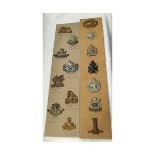 Mixed lot; 29 various British military cap badges, together with a head and shoulders photographic