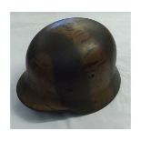German WWII steel helmet, with painted camouflage finish and leather liner