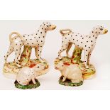 Pair of 19th century Staffordshire models of rabbits, rust coloured ears and standing on green bases