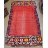 Kilim rug with central vacant red panel each end decorated with geometric designs on a mainly red