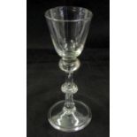 18th century wine glass with drawn trumpet bowl over a baluster and with further anulated central