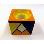 A Clarice Cliff Candlestick of cube form, the body painted in colours with an early Bizarre