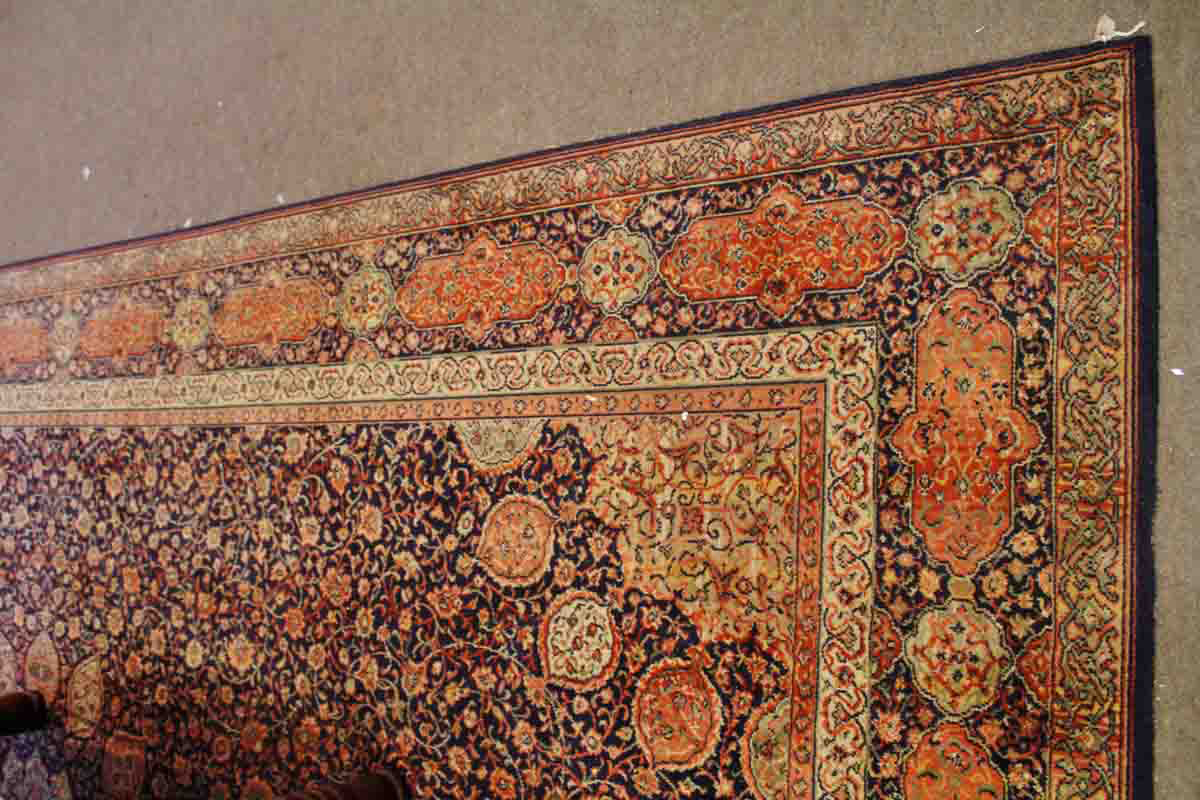 Modern Caucasian style carpet, four gulled border, central panel of extensive entwining foliage,