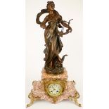 Early 20th century gilt and patinated spelter mounted pink marble figural mantel clock, the shaped