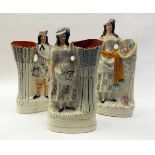 Pair of Staffordshire spill vase models of a Highlander and his female companion, each painted in