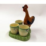 Clarice Cliff breakfast cruet, the plain green base applied with a cockerel mount, decorated in