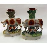 Two 19th century Staffordshire spill vase models of cow and calf, each decorated predominantly in