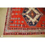 20th century Caucasian carpet, multi-gull border and large central lozenge, mainly red field, 6ft