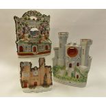 Two 19th century Staffordshire pocket watch stands formed as castles, one moulded with figures,