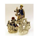 Staffordshire group of a young man and woman each with baskets with central gate and flowering