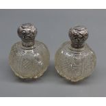 Pair of cut clear glass and silver lidded dressing table jars of circular form, 3 1/2" high