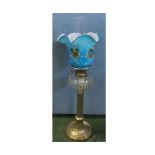 Victorian oil lamp, with clear glass chimney, frilled blue tinted floral shade over a clear glass