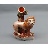 19th century Staffordshire spill vase modelled as a lion by a tree trunk, 6 1/2" high