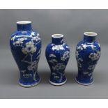 Graduated set of three late 19th or early 20th century Prunus decorated Oriental baluster vases,