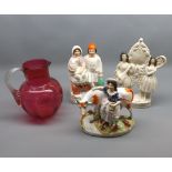 Mixed lot: three 19th century Staffordshire figures comprising a clock group, a milk maid and a