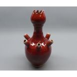 Oriental spill holder of baluster form, decorated in the Sang de Boeuf manner, 8” high