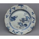 Nankin Cargo blue and white plate, decorated with stylised buildings and foliage, 8 ½” diameter