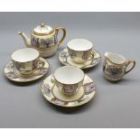 Noritake floral and gilt decorated tea set, comprising three piece tea service and two cups and