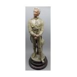 Late 19th or early 20th century bronze spelter model of military figure, raised on turned wooden