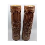 Pair of 20th century Oriental bamboo cylinder vases, carved with various figures, 18 ½” high