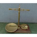 Late 19th century cast brass and mahogany beam scale, of typical form, the rectangular base with