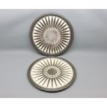 Pair of 20th century studio pottery wall plaques, decorated with sunburst design, indistinct