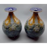Pair of Royal Doulton stoneware squat baluster vases, decorated with stylised foliage, impressed