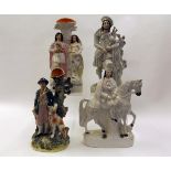 Two Staffordshire spill vase groups of gamekeeper with dog and young couple with bird and bird's