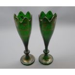 Pair of 19th century continental green and gilt decorated glass vases, of tapering form, 11" high