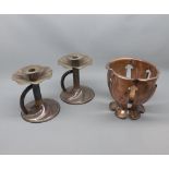 Pair of copper candlesticks in the Arts & Crafts style, fitted with looped handles, unsigned,