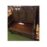 Burmese hardwood settle, with three panelled back and body, with elaborate carved detail of figures,