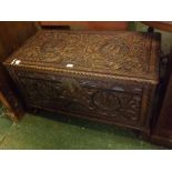 20th century Chinese camphorwood blanket box, elaborately carved all over with dragons, boats and