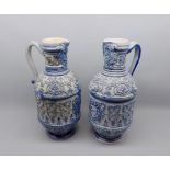 Large Rhenish stoneware pair of ewers, typically decorated with lion mask and foliate detail, 15"