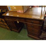 Late 19th or early 20th century twin pedestal oak desk, with one long and eight short drawers, 48"