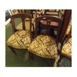 Set of four Victorian mahogany bow back dining chairs with floral upholstered seats and turned legs