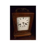 Late 19th century rosewood cased mantel clock, fitted with brass movement, raised on four small