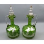 Pair of Mary Gregory green glass decanters, with clear stopper and handles, typically decorated with