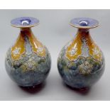 Pair of Royal Doulton stoneware squat baluster vases, decorated with stylised foliage, impressed