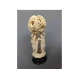 Small carved ivory group of three elephants, with concentric ball