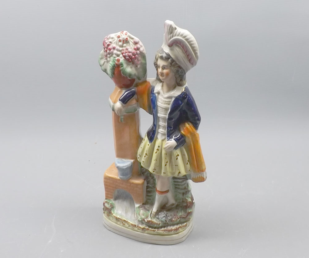 Staffordshire model of a figure beside a fountain, 10 1/2" high