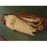 Vintage sports bag containing: vintage hockey sticks, cricket bat, cricket pads, cricket balls,