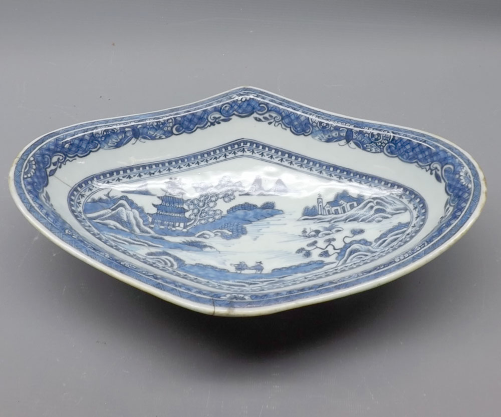 19th century Chinese oval dish, decorated in underglaze blue with a river scene (repaired), 12 1/