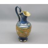 Royal Doulton stoneware ewer decorated with a gilt highlighted floral band, 9" high