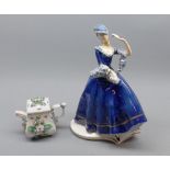 Modern Austrian figure of a female flower-seller, and further flower-encrusted small teapot (